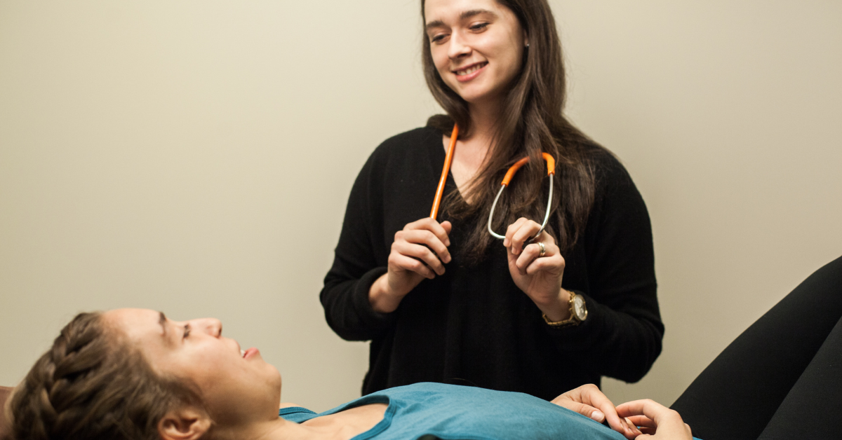 Female naturopathic doctor talking with a female patient about their long COVID symptoms.