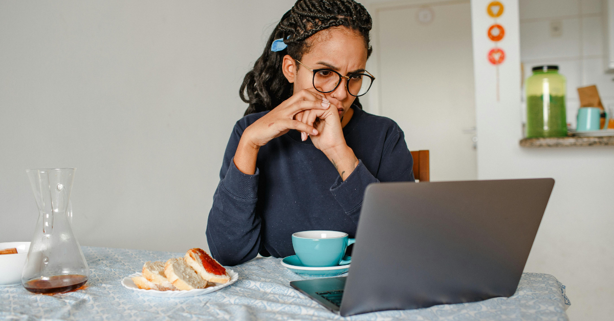 Middle-aged black woman trying to understand her medical labs report with a confused look on her face.