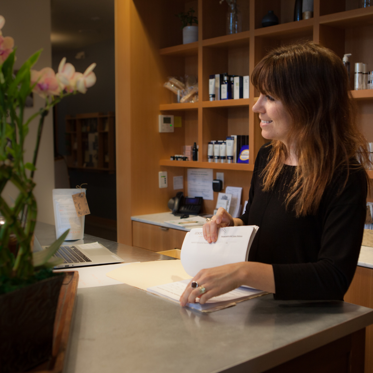 Smiling WC at the front desk checking a new client in