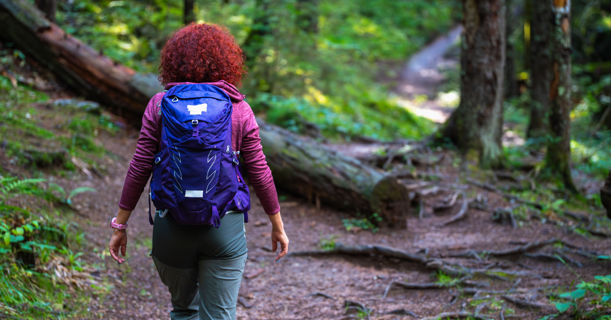Woman hiking in the Pacific Northwest trails after overcoming her long COVID symptoms.